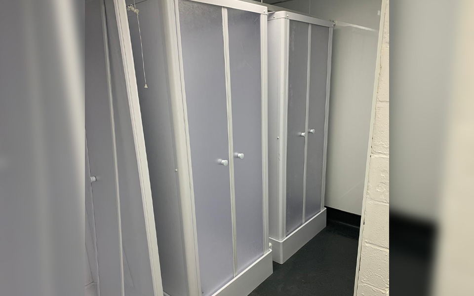 Shower cubicles installed by CCS featuring an extraction system, new flooring and fresh paint.